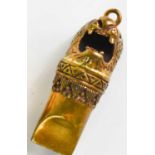 A small brass pendant whistle, in the form of a lion head.