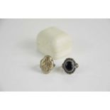 A silver locket ring together with a bulls eye agate set silver ring, the locket ring is size M, the