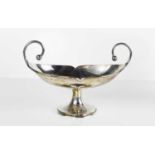 An Art Nouveau silver twin handled pedestal dish of oval form, Birmingham 1916, 2.86toz.