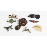 A group of Victorian and later brooches, to include a jet hand, seed pearl 'feather', flags,
