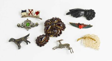 A group of Victorian and later brooches, to include a jet hand, seed pearl 'feather', flags,
