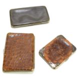 A crocodile skin and silver cigarette case and a smaller leather and silver cigarette case