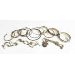 A group of twelve silver bangles, including Victorian examples, and three pocket watch chains and