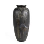 A Japanese bronze vase, depicting Mount Fuji with silvered peak, and raised bamboo to the fore,