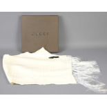 A Gucci cream silk scarf with silk knotted fringe, in the original Gucci box.