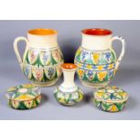 A group of Syrian tin glazed earthenware pottery to include jugs and trinket boxes.