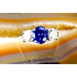 A platinum, blue sapphire and diamond three stone ring, size O, 9.6g.