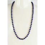 A 9ct gold and lapiz lazuli beaded necklace each bead interspersed with a gold bead, and gold clasp,