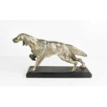 A white metal model spaniel, with detailed worked fur, raised on a slate plinth.