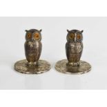 A pair of silver place settings in the form of owls, by Sampson Mordon Co., Chester 1907, inset with