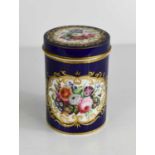 A 19th century cylinder form box with dark blue ground, painted with flowers.
