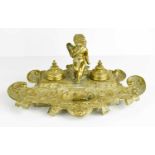 A Victorian brass double inkwell with cherub.