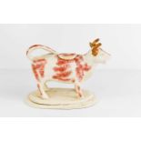 An early 20th century cow creamer with original cover.