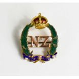 A New Zealand gold and enamel regimental brooch, bearing initials NZ beneath a crown.