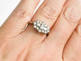 A platinum and diamond cluster ring, by Dawson of Stamford, the three baguette cut diamonds to the