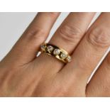 A 18ct gold and diamond five stone ring, the five brilliant cut diamond collets are movable within a