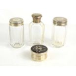 A silver and tortoiseshell pill box together with silver and glass dressing table bottles.