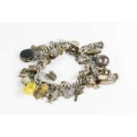 A silver charm bracelet, with various charms.