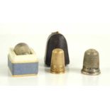 A gold thimble together with two silver examples, the gold thimble has been tested to be at least