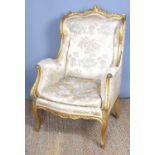 A 19th century French giltwood chair, in silk damask, high back and sides, 105 by 75cm.