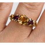 A 9ct gold Victorian style mixed cut citrine and garnet ring, size O, 2.38g.