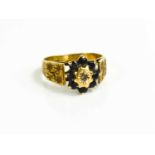 A vintage 9ct gold ring with central chip diamond surrounded by sapphires, size N 1/2, 3.4g.