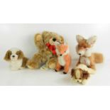 A group of Steiff animals to include two foxes and two spaniels together with Bobby the bear.