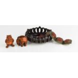 Two Japanese inro carved beads, together with a cinnabar and metalwork bracelet, and a hardwood