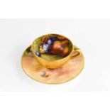A Royal Worcester miniature cup and saucer, painted with fruit to a mossy ground, circa 1930, the