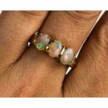 A 9ct gold oval opal trilogy ring, size R, 3g.