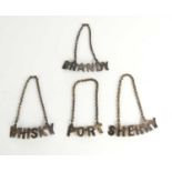 Four silver plate decanter labels comprising of port, whisky, sherry and brandy.