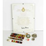 A group of medal pins, Womens Land Army badge together with the corresponding certificate signed