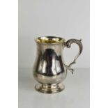 A 19th century silver tankard with gilded interior and shaped handle decorated with leaf design, 8.