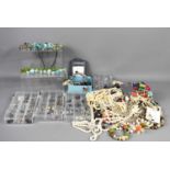 A large group of jewellery, to include three boxes of earrings, beaded necklaces, bracelets and