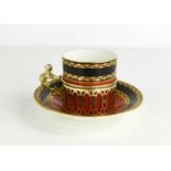 A Royal Worcester coffee can and saucer, with puce mark 1920s, with solid silver holder, pierced
