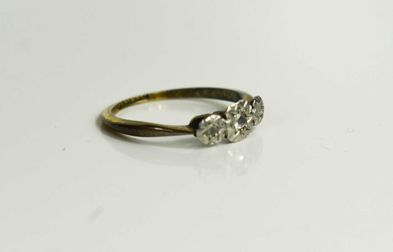 A platinum and 9ct gold ring, with three chip diamonds in illusion setting, size J, 1.6g. - Bild 3 aus 3