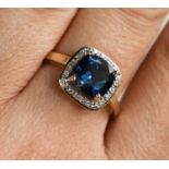 A 9ct gold and blue topaz and diamond ring, with a cushion cut topaz, size R ½, 2.64g.
