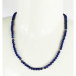 A 9ct gold and lapiz lazuli beaded necklace, 23g, 58cm long