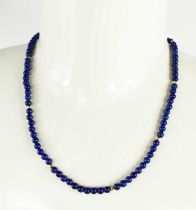 A 9ct gold and lapiz lazuli beaded necklace, 23g, 58cm long