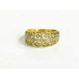 A 14ct gold and diamond lace effect ring, the ring set with thirty two individual diamonds, size