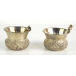 A pair of silver thistle form salts and spoons, 1.24toz.