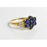 A 9ct gold cabochon sapphire flower head cluster ring, size R, 2g.