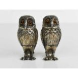 A silver salt and pepper in the form of owls, by William Comyns & Sons Ltd, set with glass eyes,