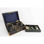 A vintage jewellery box containing a group of sterling silver bangles and bracelets, silver