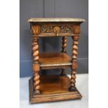 A three tier oak side table, with single drawer and barley twist columns.