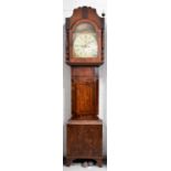 A 19th century oak and mahogany longcase clock, the arched painted Roman numeral dial having a