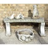 A reconstituted stone bench together with a group of animals and a stone planter.