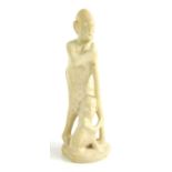 An African polished stone figure of a mother and child, 24cm tall.