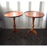 A pair of 20th century walnut wine tables, with pie crust edge.