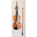 An antique Violin and bow, maple with two piece back.